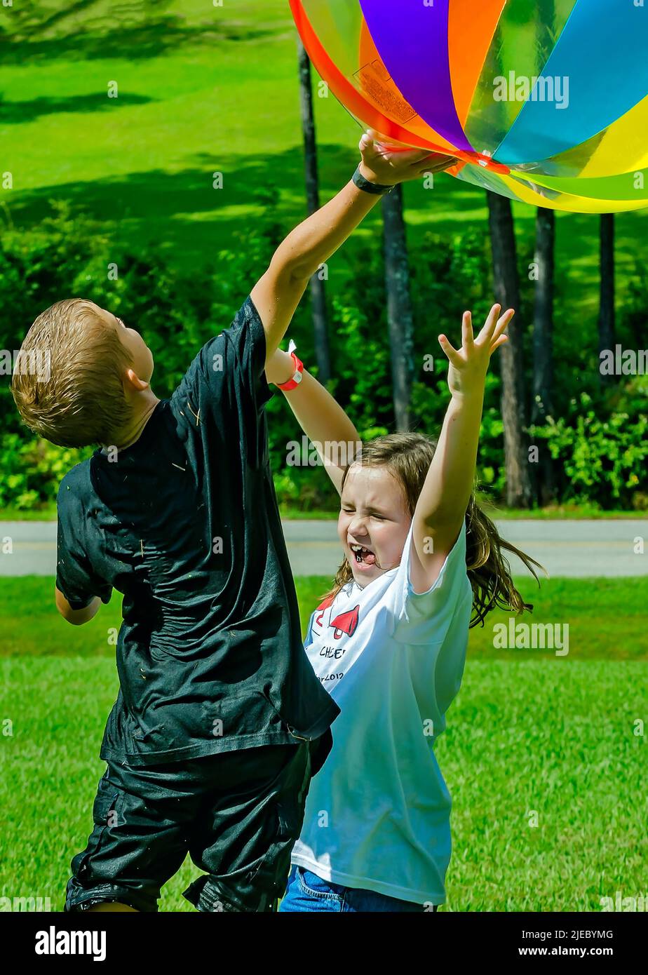 Children toss a giant beach ball, July 27, 2012, in Columbus, Mississippi. Stock Photo