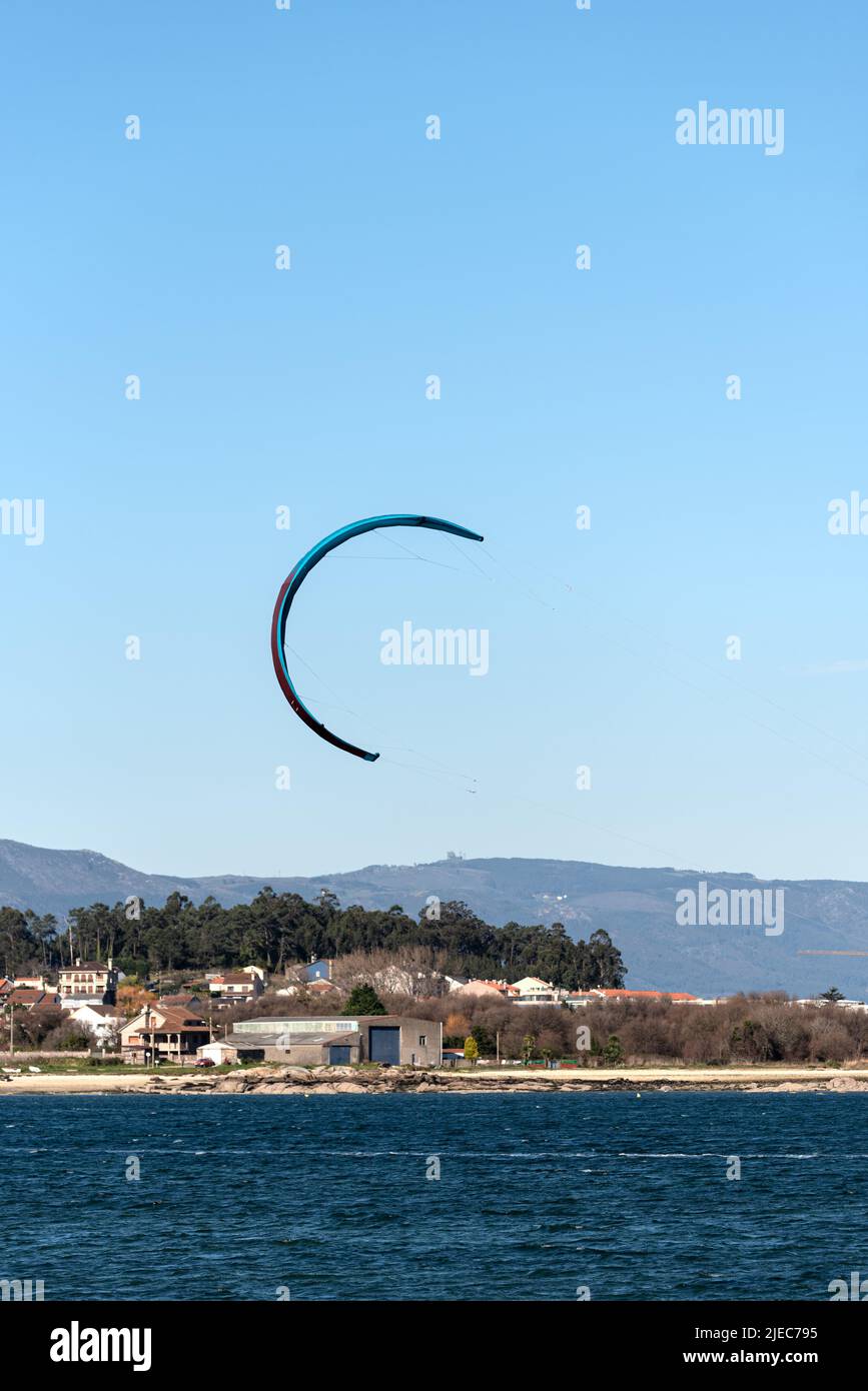 kitesurfing kite flying over clear skies inj the beach Stock Photo