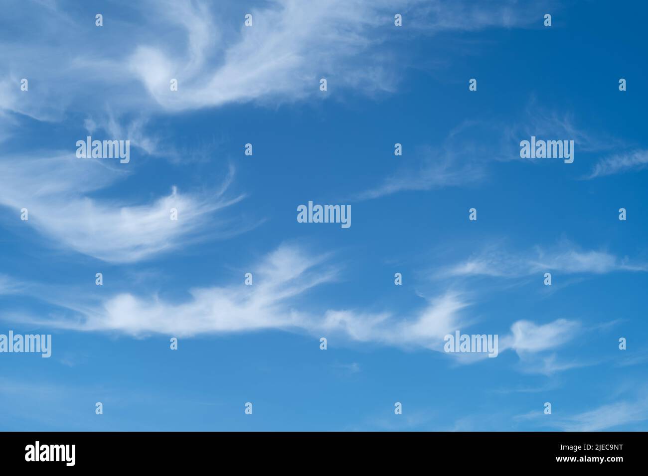 Unusual patterns of wispy clouds against a blue sky on a summer day Stock Photo
