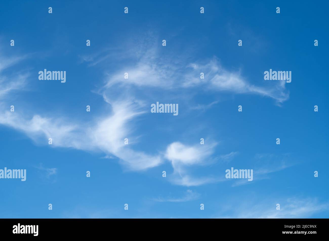 Unusual patterns of wispy clouds against a blue sky on a summer day Stock Photo