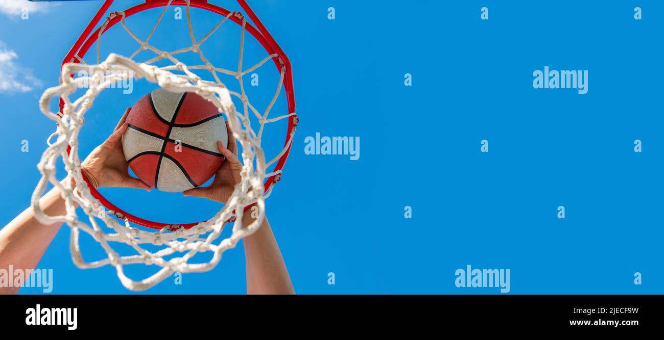 sport success. scoring while basketball game. ball goes through basket