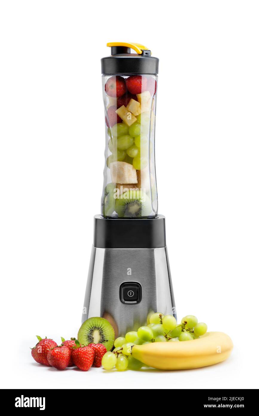 Smoothie blender is reaty to blend some strawberries, pineapples, bananas and kiwi inside it and