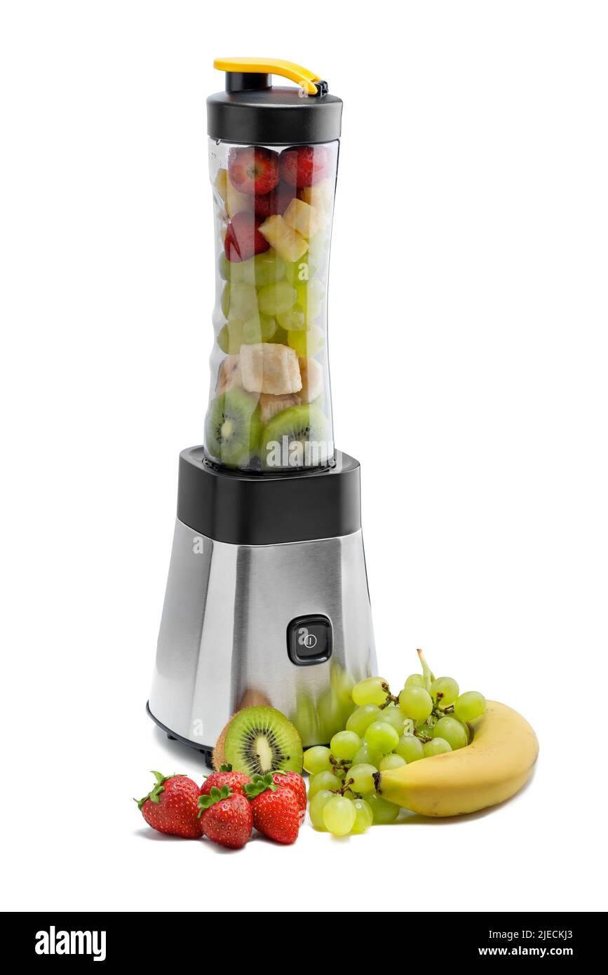 Smoothie blender is reaty to blend some strawberries, pineapples