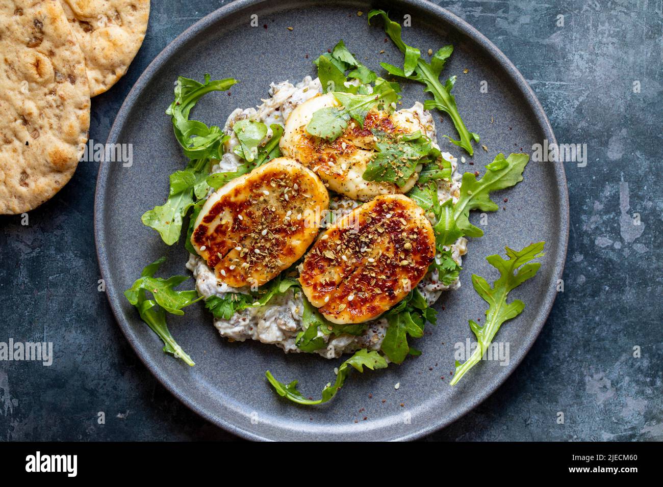 Aubergine and yogurt dip with halloumi and zaatar mix Stock Photo Alamy