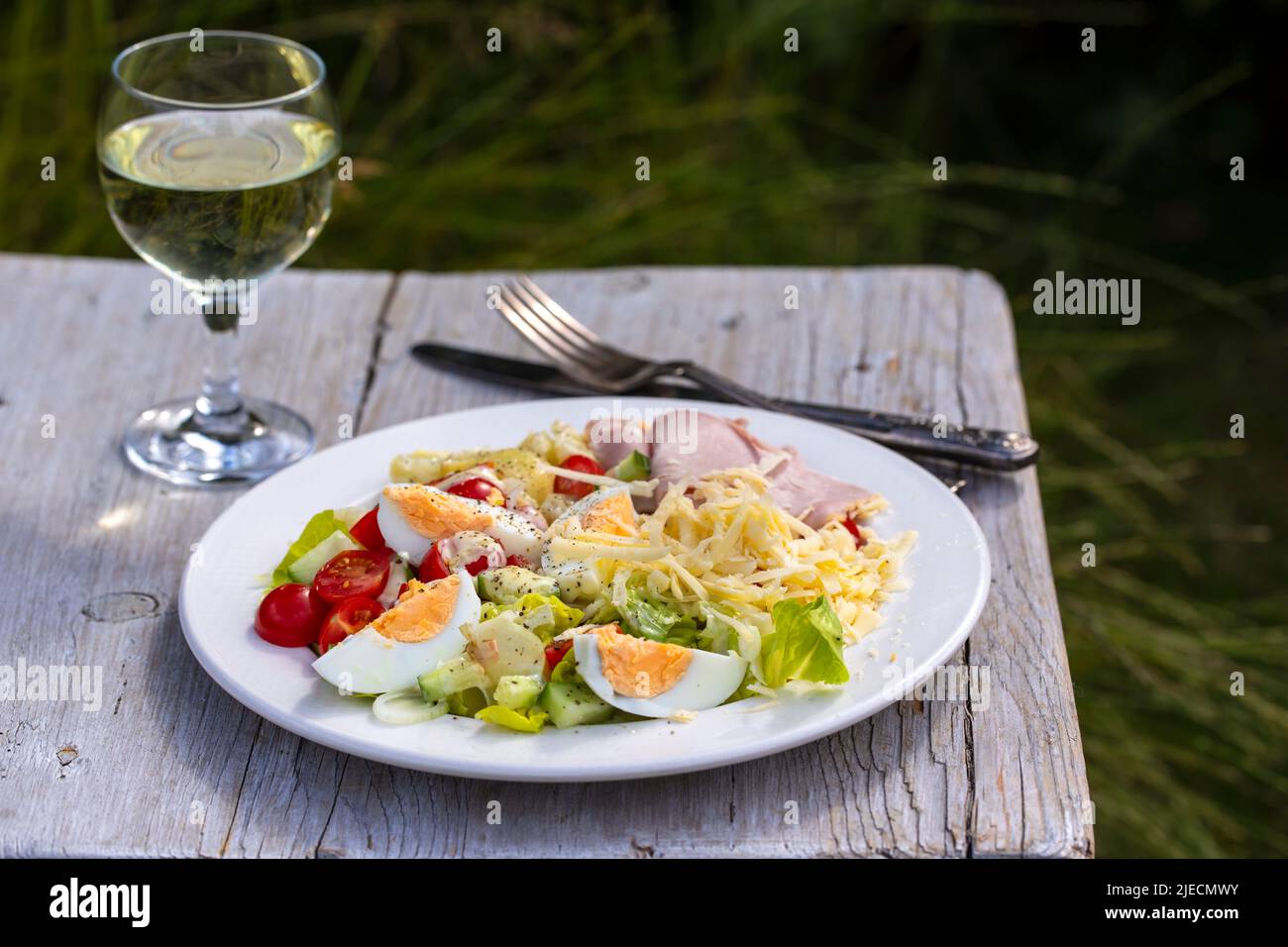 Simple summer meal with potatoes, salad, egg, cheese and ham Stock Photo