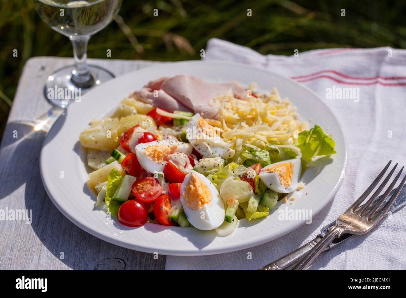 Simple summer meal with potatoes, salad, egg, cheese and ham Stock Photo