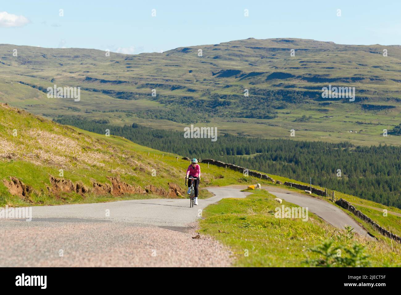 Teenager cycling on Isle of Mull, Scotland Stock Photo
