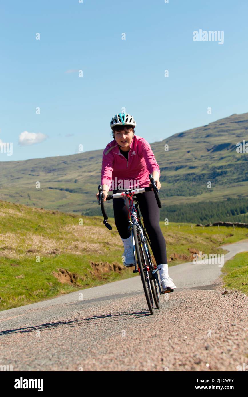 Teenager cycling on Isle of Mull, Scotland Stock Photo