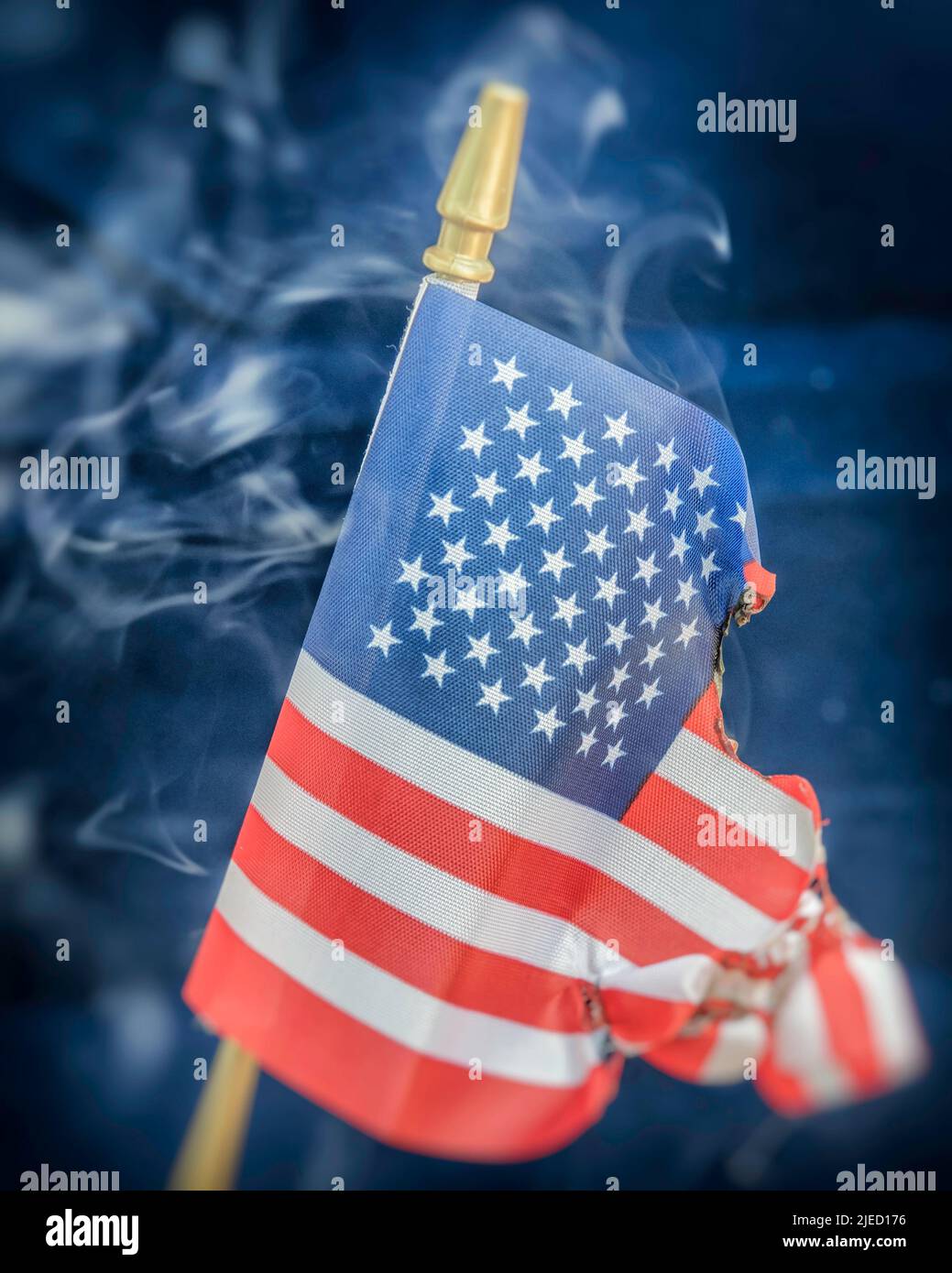 Close up of a smoking American flag that is burning. Stock Photo