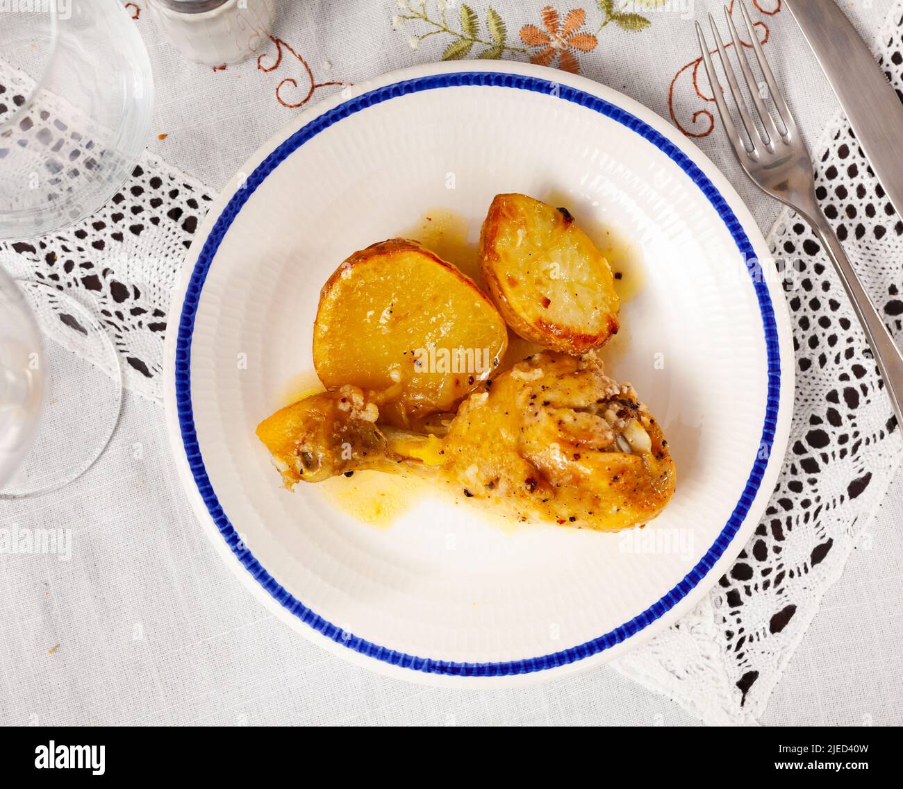 Just cooked chicken leg with fried potatoes Stock Photo Alamy
