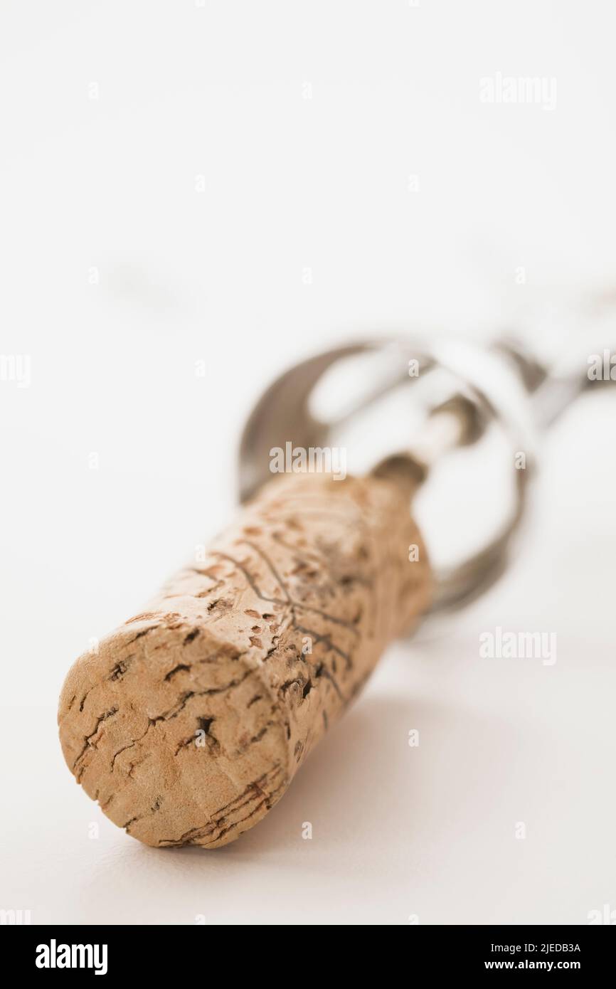 Close-up of wine bottle cork and corkscrew on white background. Stock Photo