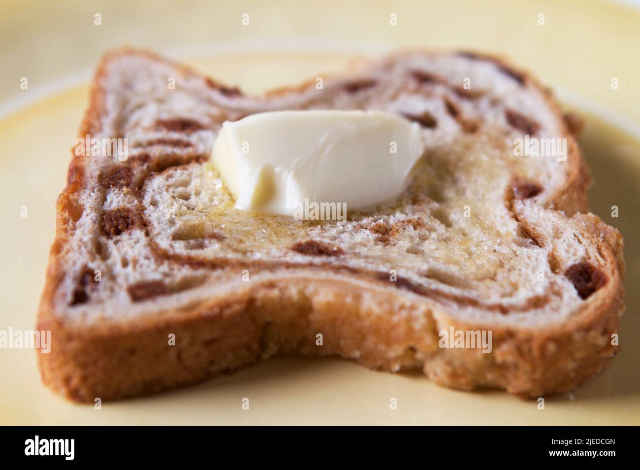Cinnamon toast with melting butter on yellow plate. Stock Photo