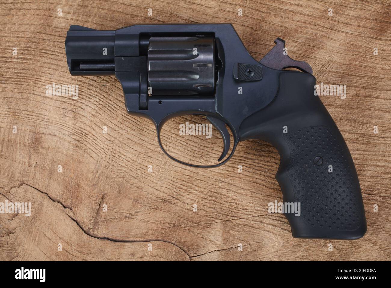 Cocked and locked revolver on wooden table background Stock Photo