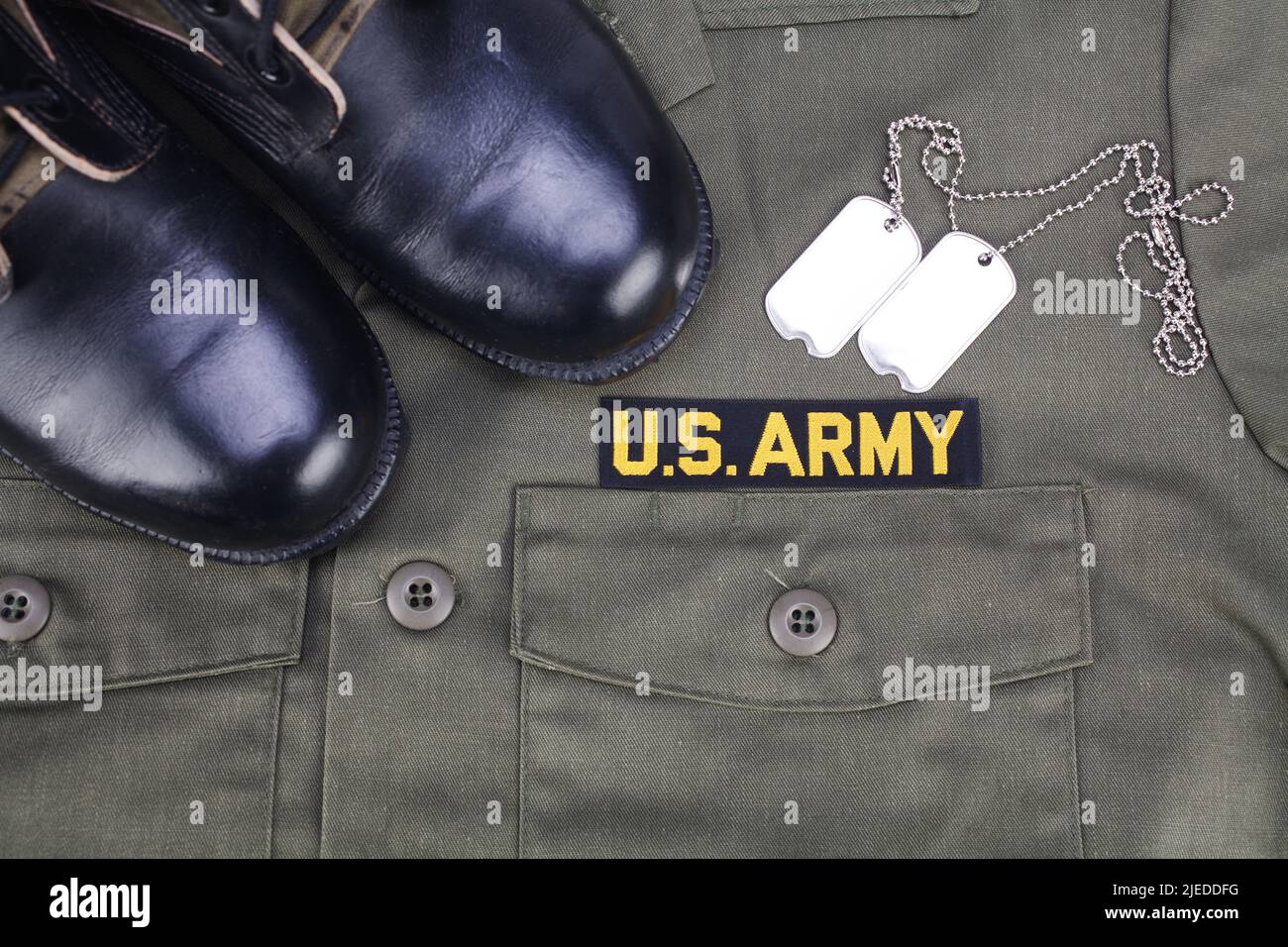 Uncle sam wants you - U.S. Army Branch Tape with dog tags and boots on olive green uniform background Stock Photo