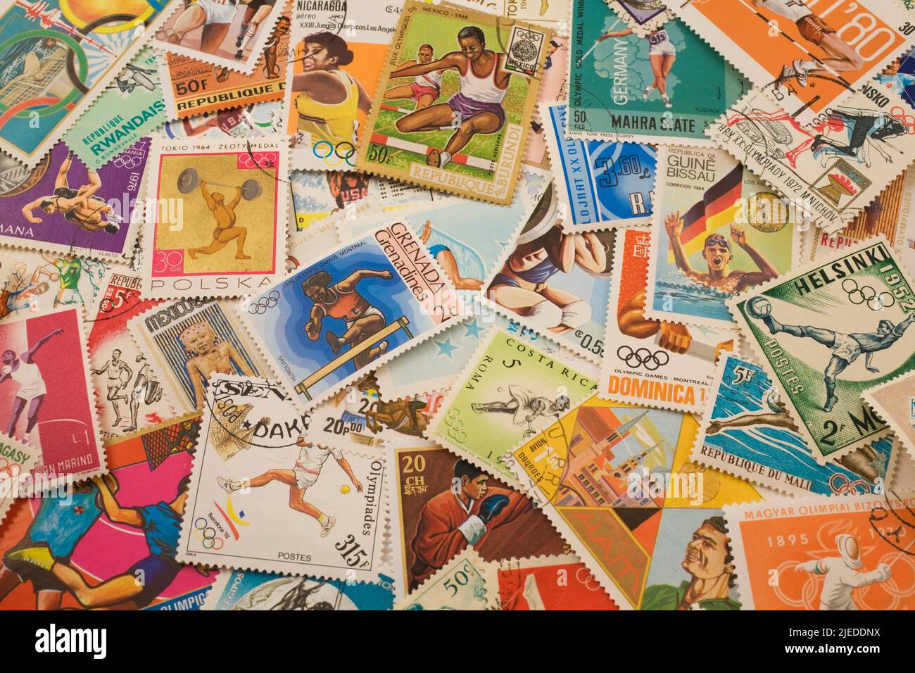 Assorted old postage stamps from various Countries commemorating various Summer Olympic Sports. Stock Photo