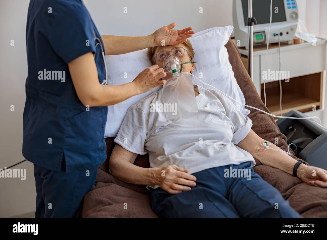 Doctor putting on a breathing mask and control temperature on a female