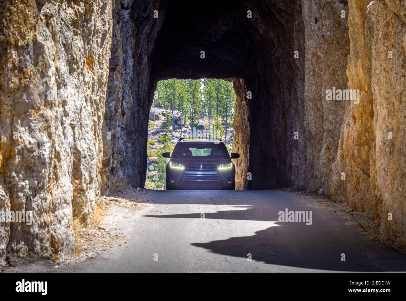 Car in Needles Eye Tunnel on the Needles Highway in Custer State Park
