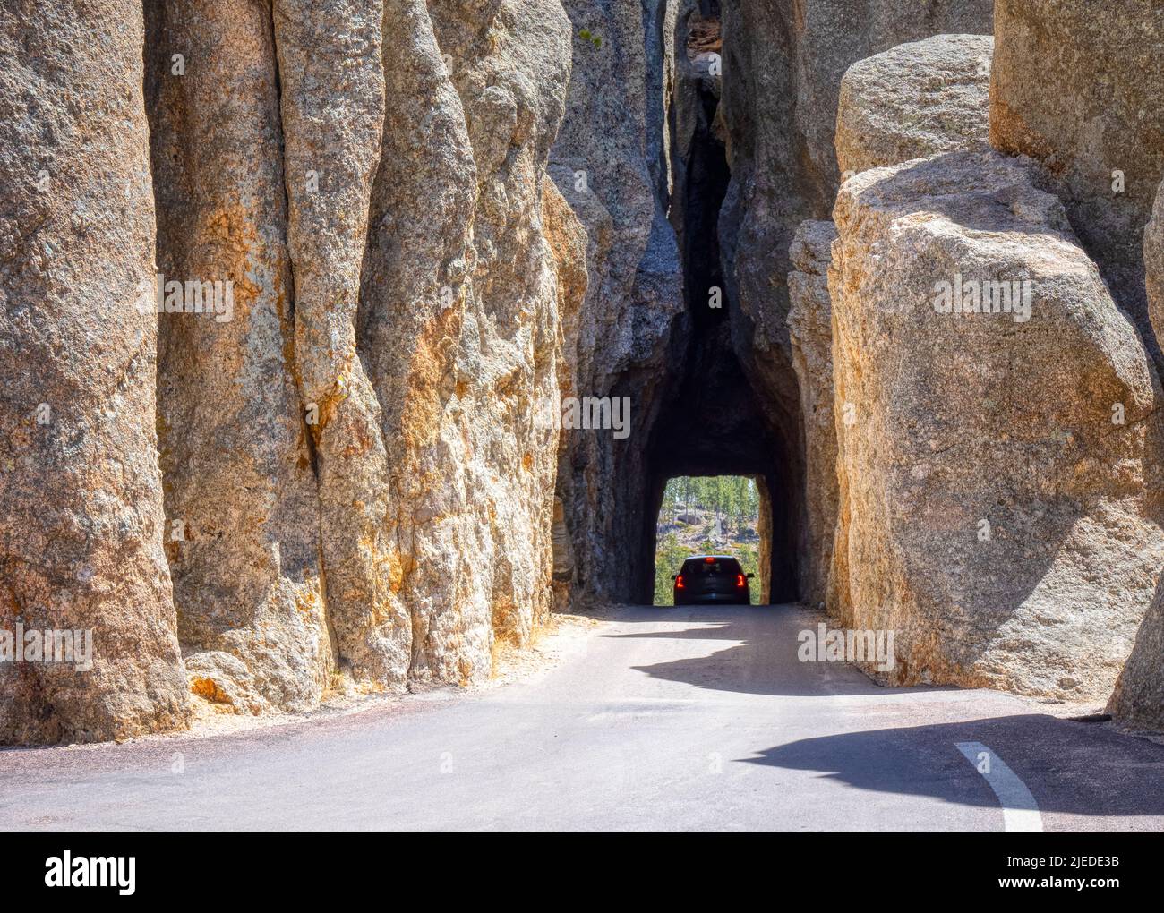 Car in Needles Eye Tunnel on the Needles Highway in Custer State Park