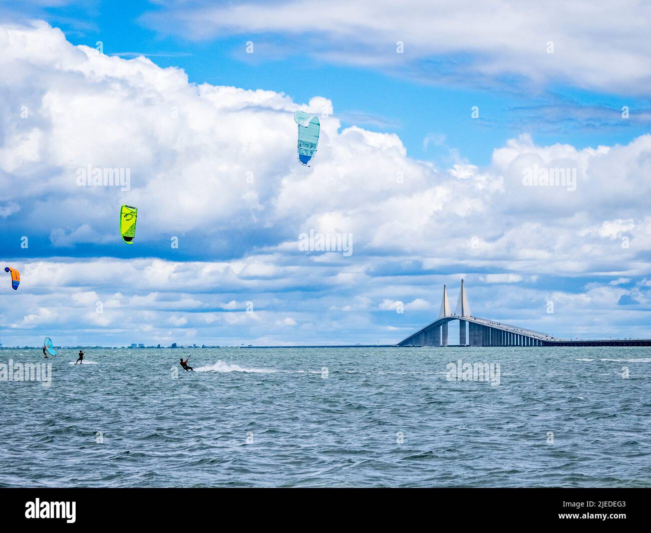 Kiteboarders or Kitesurfers in Tampa Bay with The Sunshine Skyway Bridge in the background in St Petersburg Florida USA Stock Photo