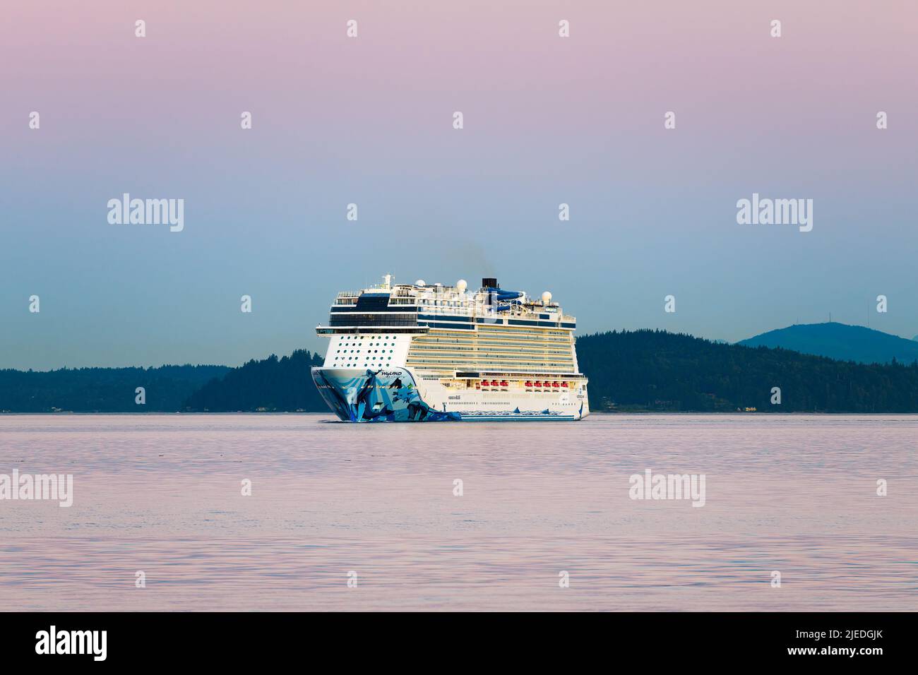 Seattle, WA, USA - June 25, 2022; NCL cruise ship Norwegian Bliss sailing in dawn light as it crosses Elliott Bay at end of Alaskan Cruise Stock Photo