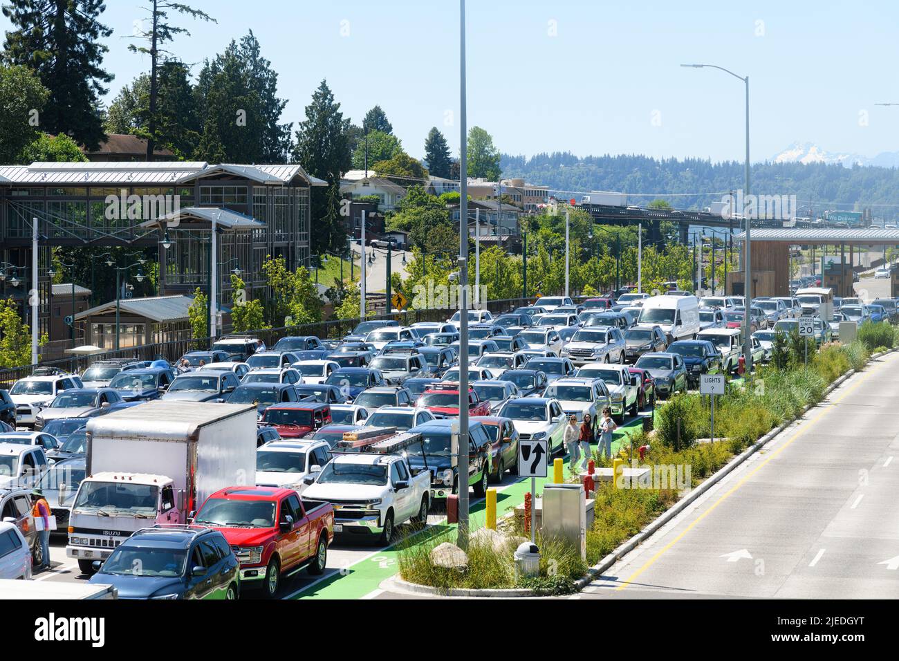 Mukilteo, WA, USA - June 25, 2022; Tourists and workers wait in the hot sun at the Mukilteo Ferry Dock on a sunny Friday afternoon in summer Stock Photo