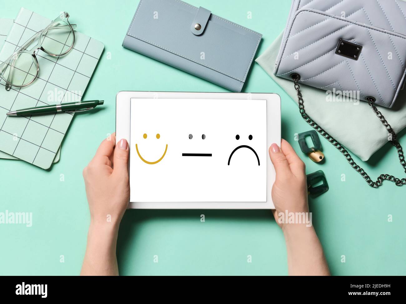 Woman with different stylish accessories and tablet computer with ...