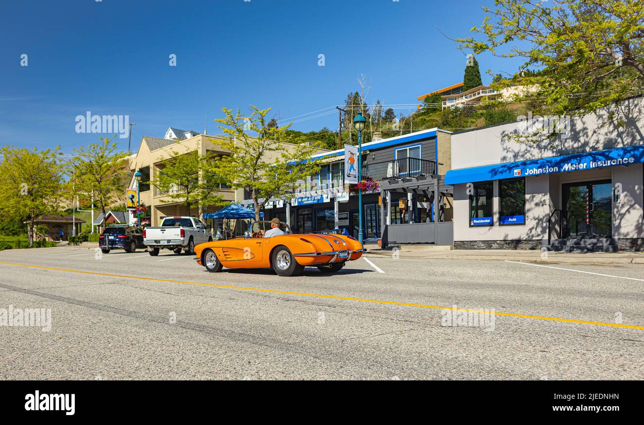 An orange 1959 Chevrolet Corvette Convertible driving in a town. Front view. Vintage Chevrolet Corvette a classic cabrio car-June 7,2022-Peachland BC Stock Photo