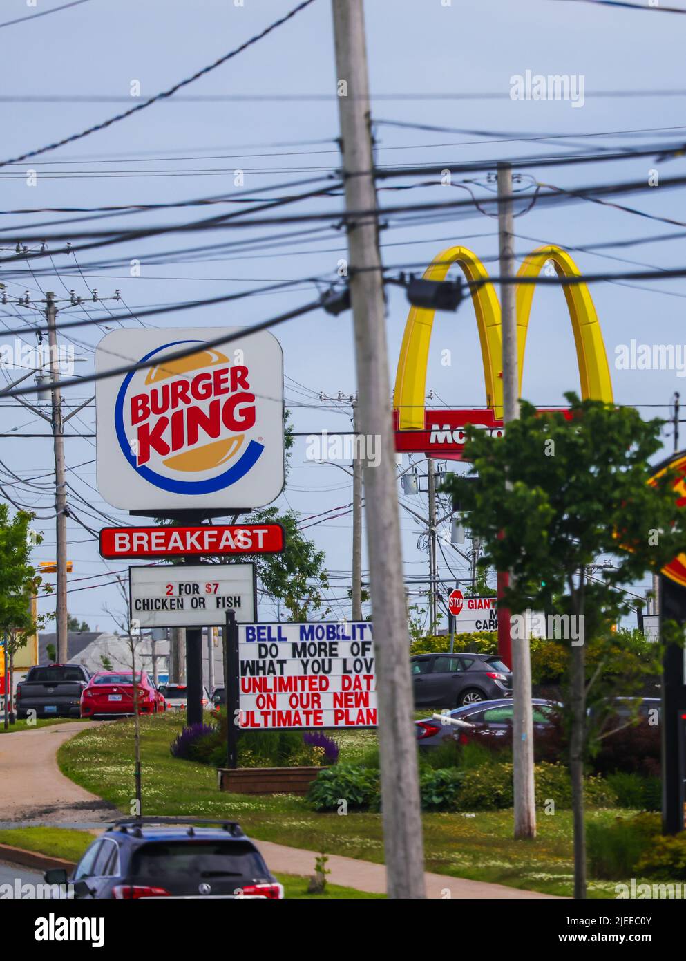 McDonalds and Burger King restaurants road side banners  in a single frame. An American chain of fast-food. HALIFAX, NOVA SCOTIA, CANADA - JUNE 2022 Stock Photo