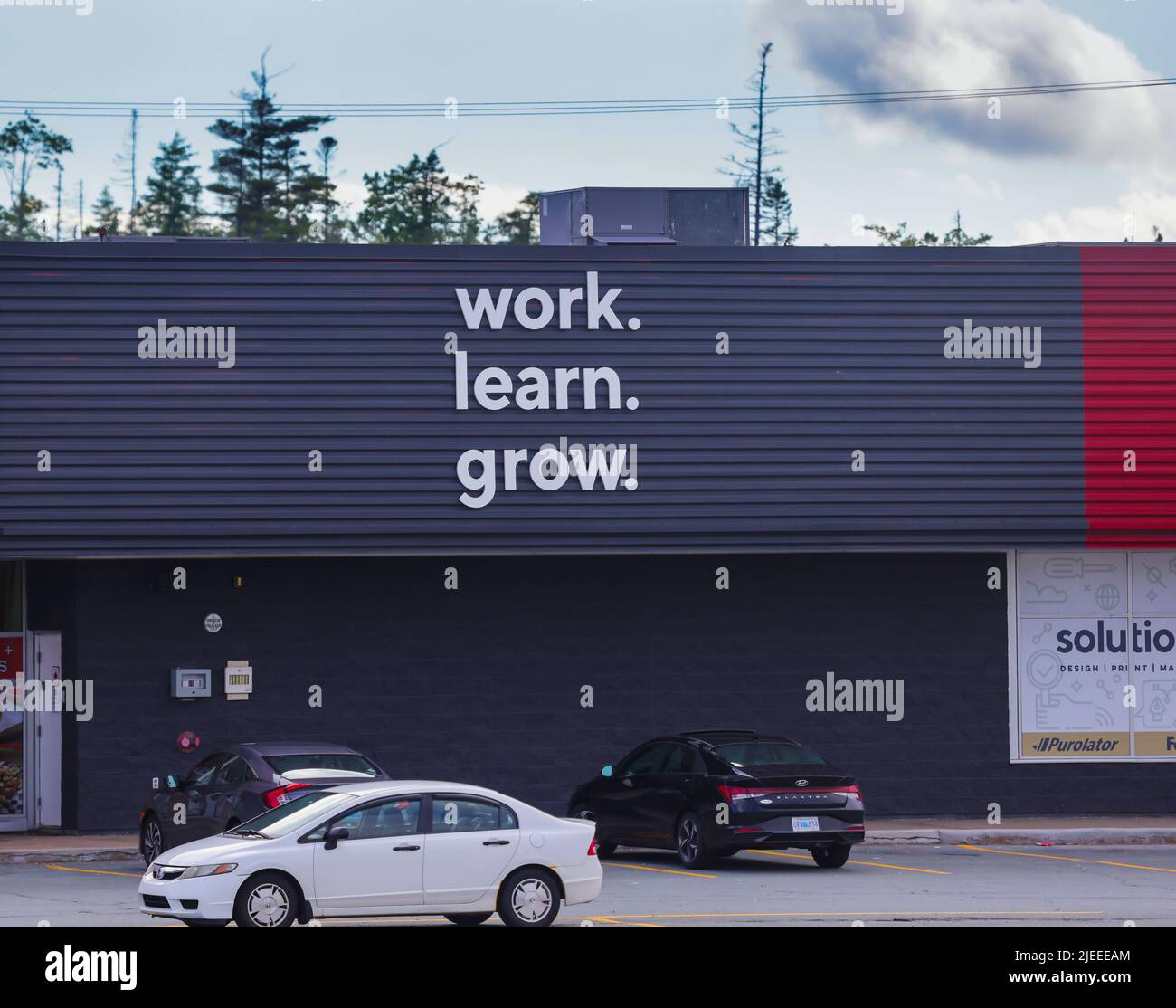 Staples Storefront motto 'Work. Learn. Grow'. Staples is an American retail company specialized in office supplies. HALIFAX, NOVA SCOTIA, CANADA Stock Photo