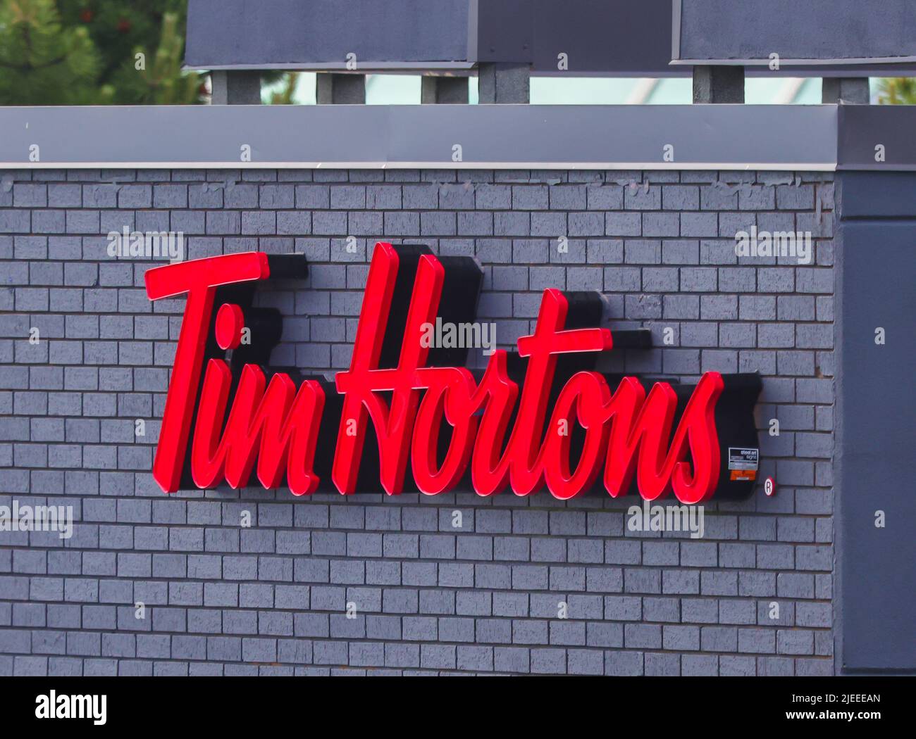 Tim Hortons sign on storefront. Canada's quick serve restaurant chain akaTim's or Timmies serves coffee. doughnuts, etc, Halifax, Nova Scotia, Canada Stock Photo