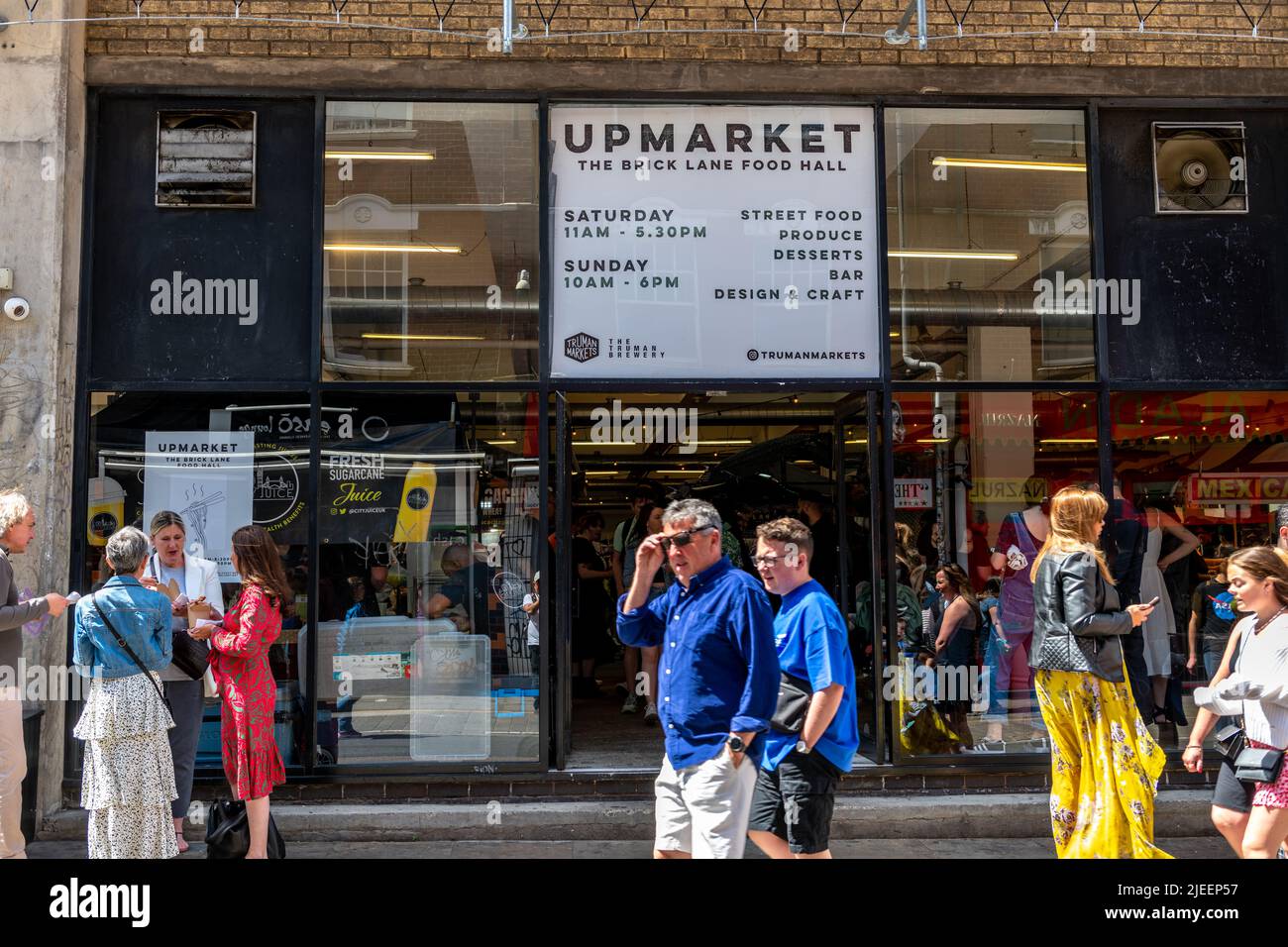 London. UK-06.26.2022. The sign and entrance of Upmarket in Brick Lane which attract a large crowd of tourists and visitor to its popular food stalls. Stock Photo