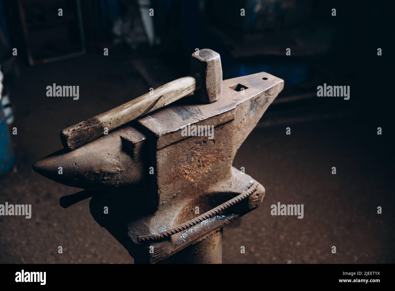A blacksmith's hammer lies on an anvil. Stock Photo