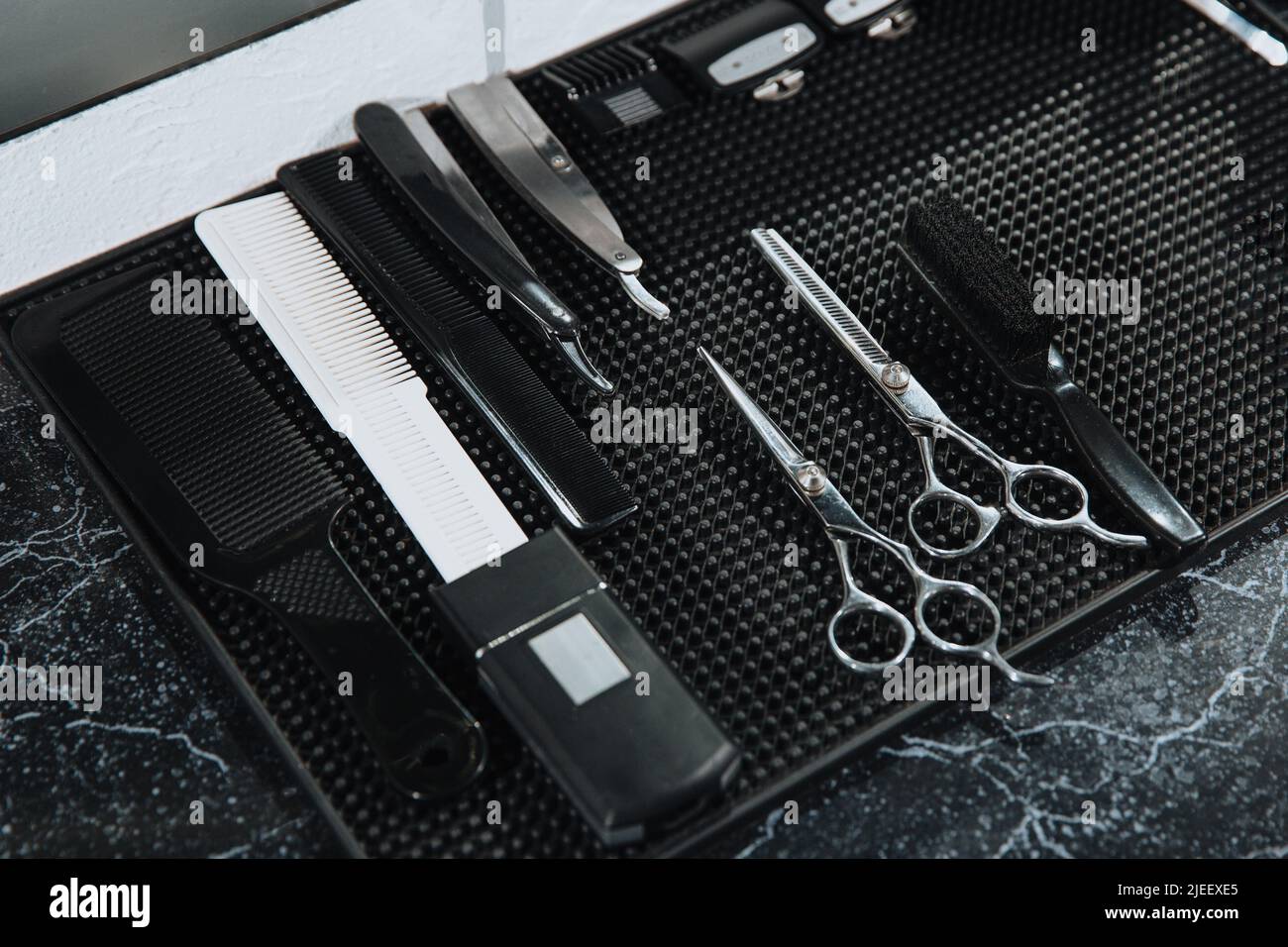 Professional scissors on black background. Hairdressing industry. Professional hairdressing tools. Stock Photo