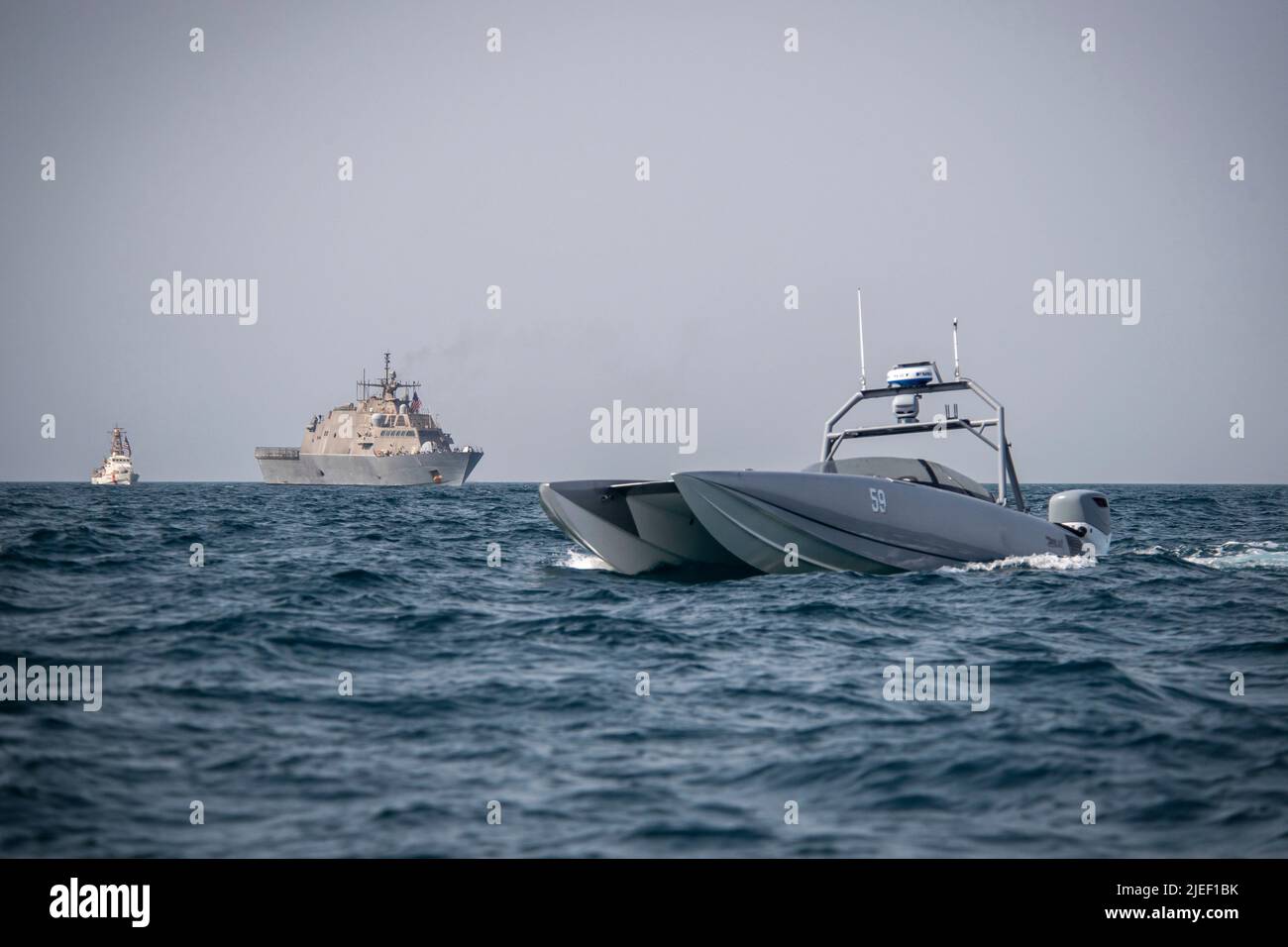 220626-N-NS602-1204 ARABIAN GULF (June 26, 2022) A Devil Ray T-38 unmanned surface vessel, littoral combat ship USS Sioux City (LCS 11), and U.S. Coast Guard cutter USCGC Baranof (WPB 1318) sail in the Arabian Gulf, June 26. U.S. naval forces regularly operate across the Middle East region to help ensure security and stability. (U.S. Navy photo by Chief Mass Communication Specialist Roland A. Franklin) Stock Photo