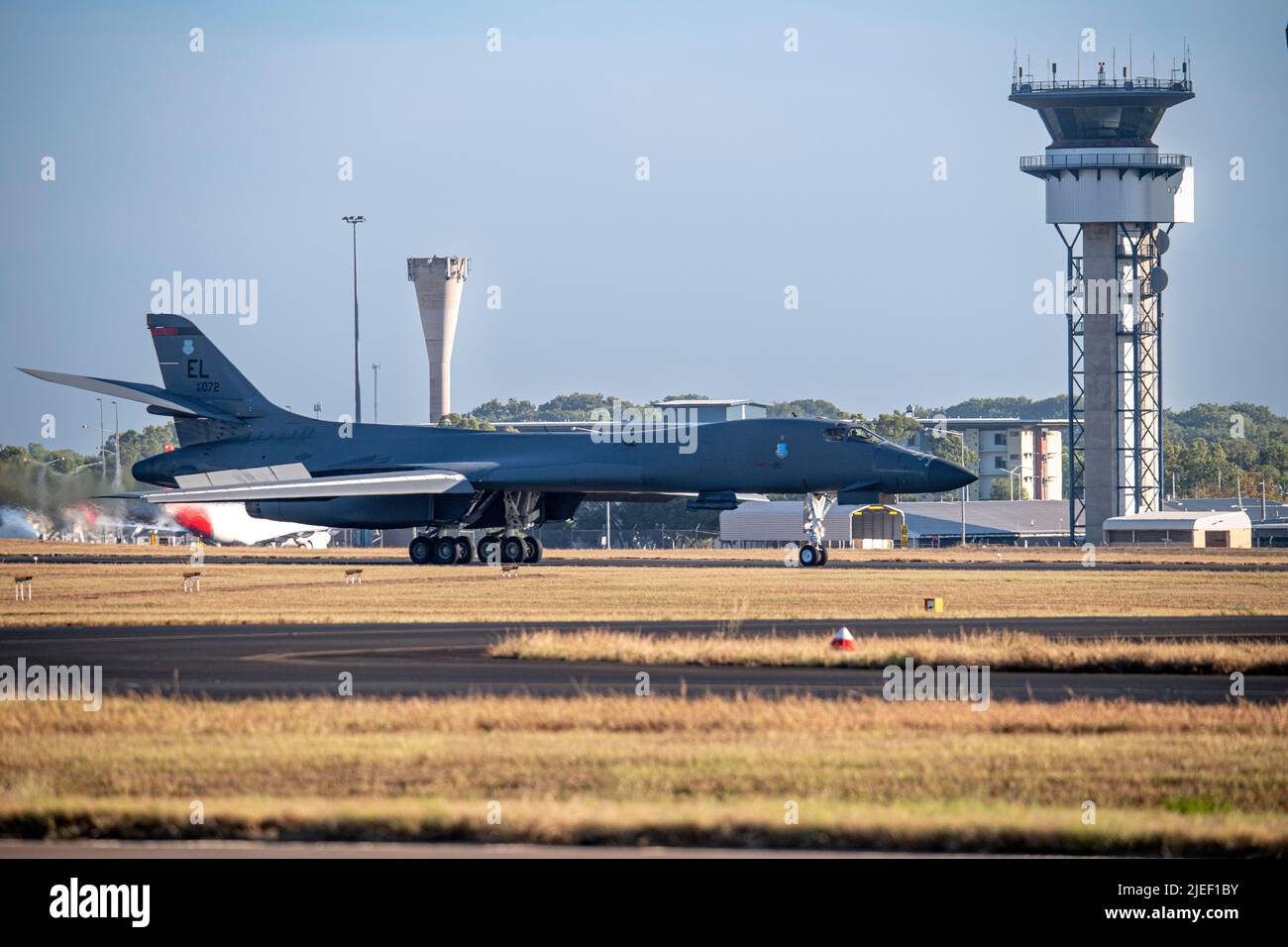 A U.S. Air Force B-1B Lancer assigned to the 34th Expeditionary Bomb Squadron, Ellsworth Air Force Base, South Dakota, taxies past the Darwin airport control tower on its way to the Royal Australian Air Force base to take on fuel in Darwin, Northern Territory, Australia, June 22, 2022. Bomber missions contribute to joint force lethality and deter aggression in the Indo-Pacific by demonstrating United States Air Force ability to operate anywhere in the world at any time in support of the National Defense Strategy. (U.S. Air Force Photo by Tech. Sgt. Chris Hibben) Stock Photo