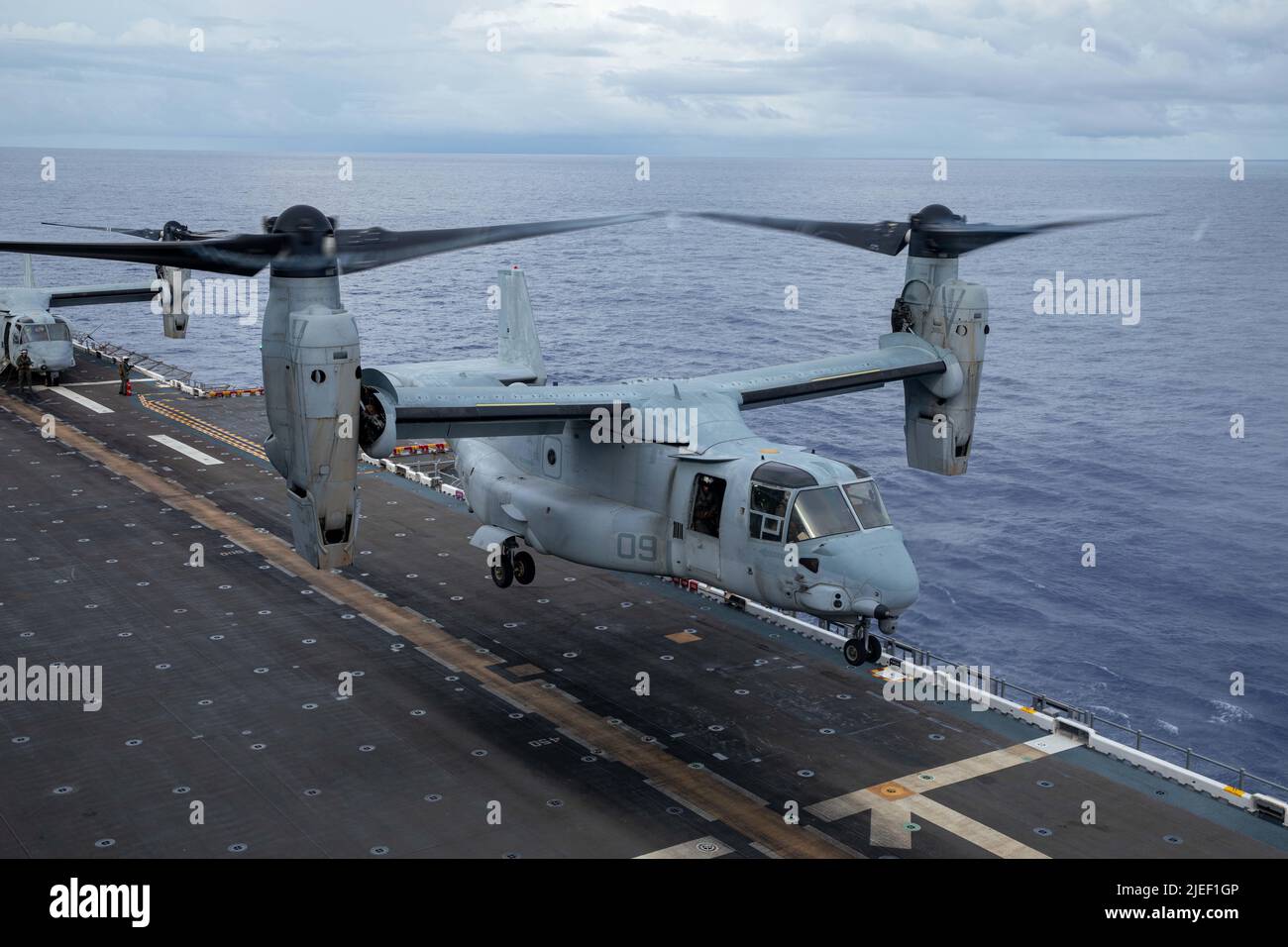 A U.S. Marine Corps MV-22B Osprey aircraft with Marine Medium Tiltrotor Squadron (VMM) 262 lands aboard the amphibious assault ship USS Tripoli (LHA 7) while underway, June 25, 2022. VMM-262 is operating in the U.S. 7th Fleet area of operations to enhance interoperability with allies and partners, and serve as a ready response force to defend peace and maintain stability in the Indo-Pacific region. (U.S. Marine Corps photo by Cpl. Gabriel Durand) Stock Photo