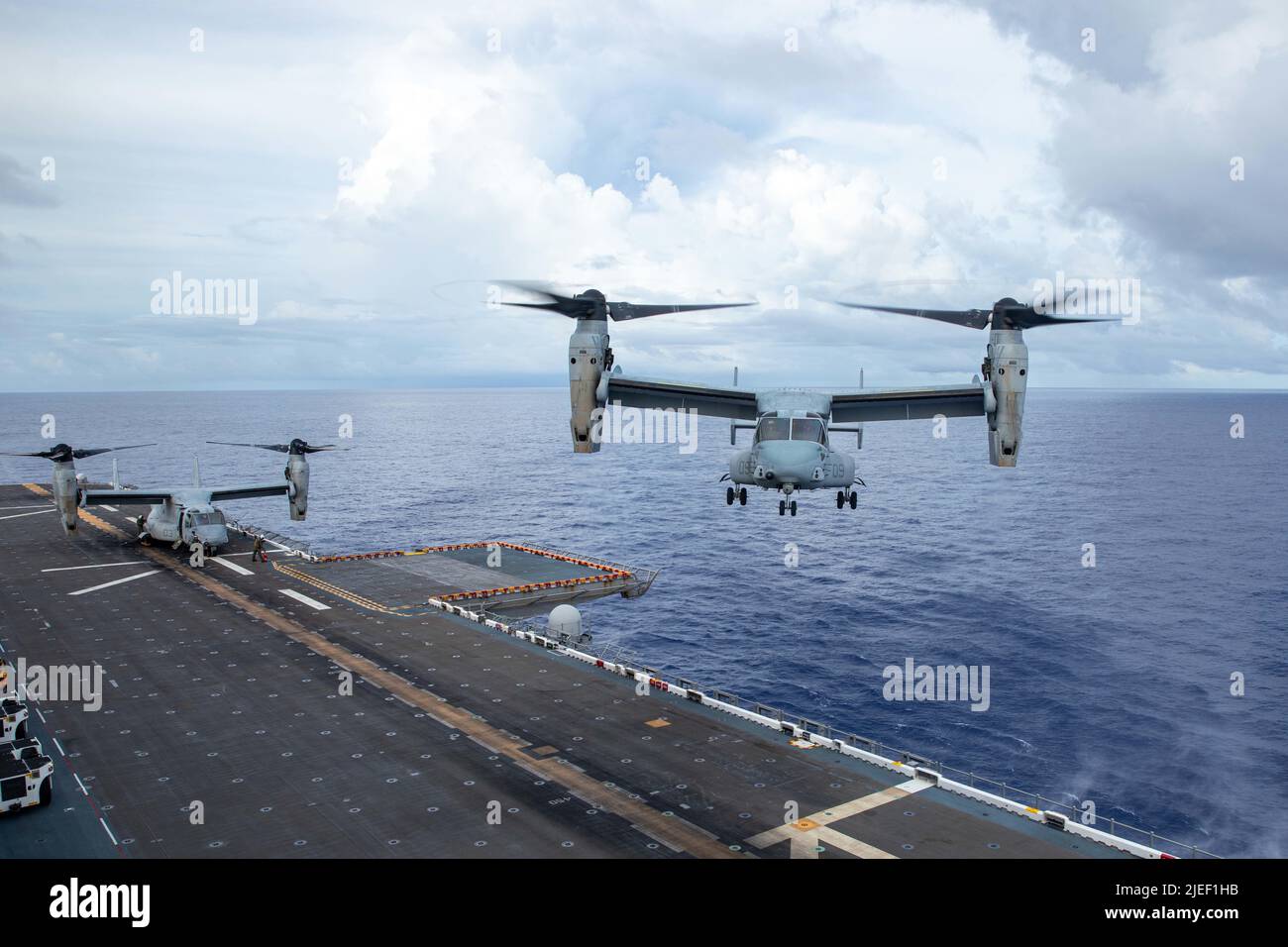 A U.S. Marine Corps MV-22B Osprey aircraft with Marine Medium Tiltrotor Squadron (VMM) 262 prepares to land aboard the amphibious assault ship USS Tripoli (LHA 7) while underway, June 25, 2022. VMM-262 is operating in the U.S. 7th Fleet area of operations to enhance interoperability with allies and partners, and serve as a ready response force to defend peace and maintain stability in the Indo-Pacific region. (U.S. Marine Corps photo by Cpl. Gabriel Durand) Stock Photo