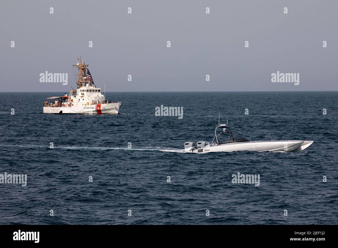 220626-A-JJ498-1228 ARABIAN GULF (June 26, 2022) A Devil Ray T-38 unmanned surface vessel and U.S. Coast Guard cutters USCGC Baranof (WPB 1318) sail in the Arabian Gulf, June 26. U.S. naval forces regularly operate across the Middle East region to help ensure security and stability. (U.S. Army photo by Spc. Ian Miller) Stock Photo