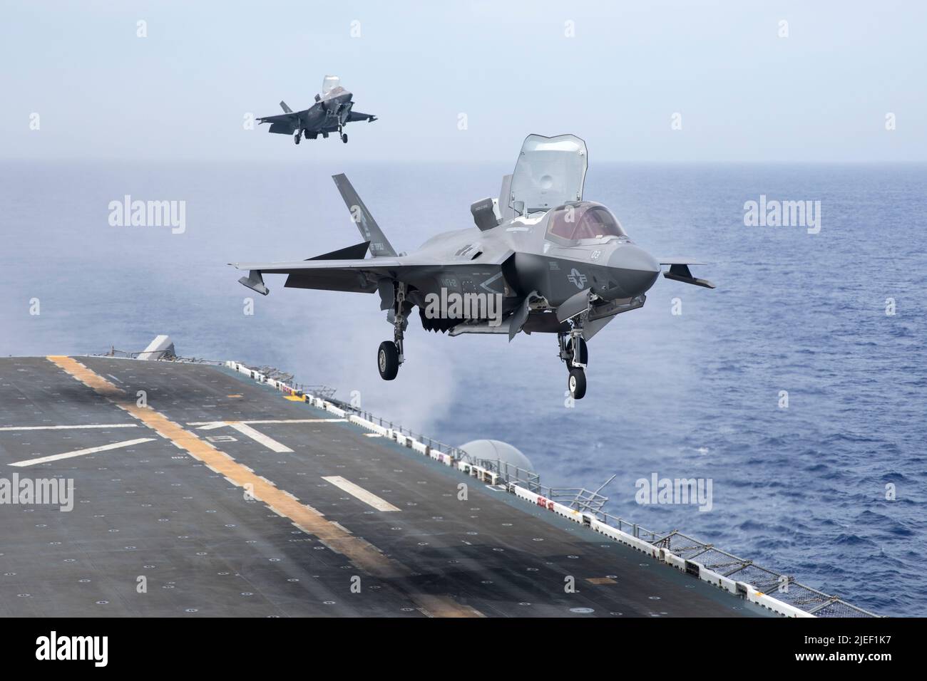 U.S. Marine Corps F-35B Lightning II aircraft with Marine Fighter Attack Squadron (VMFA) 121 approach the amphibious assault carrier USS Tripoli (LHA 7), while underway, June 11, 2022. Marines with VMFA-121, based out of Marine Corps Air Station Iwakuni, Japan, are conducting flight operations within U.S. 7th Fleet in support of a free and open Indo-Pacific. (U.S. Marine Corps photo by Sgt. Jackson Ricker) Stock Photo