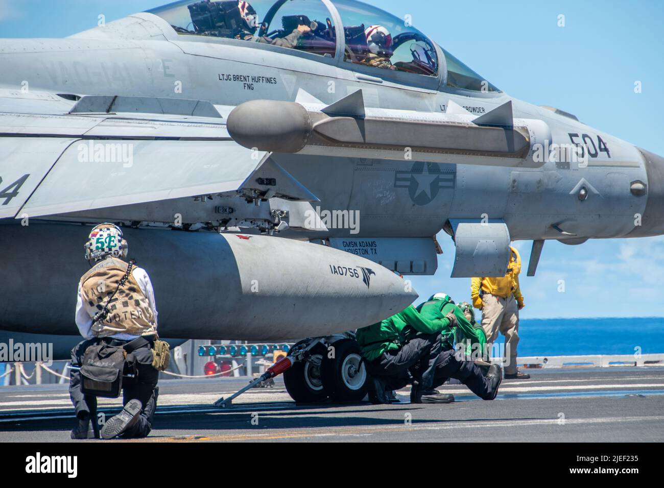 220620-N-BR419-1035 PHILIPPINE SEA (June 20, 2022) Sailors conduct catapult checks as an EA-18G Growler attached to the Shadowhawks of Electronic Attack Squadron (VAQ) 141, prepares to launch from the flight deck of the U.S. Navy’s only forward-deployed aircraft carrier USS Ronald Reagan (CVN 76). The primary role of EA-18G Growlers is to disrupt the ability to communicate between units in combat through the use of electronic warfare. Ronald Reagan, the flagship of Carrier Strike Group 5, provides a combat-ready force that protects and defends the United States, and supports alliances, partner Stock Photo