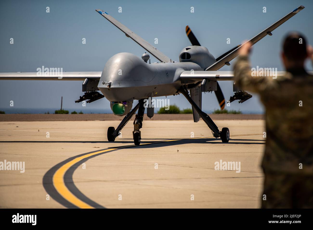 The MQ-9 Reaper Aircraft assigned to 163d Attack Wing completes autonomous landing and is taxied to maintenance position on San Clemente Island, California on June 23. 2022. The MQ-9 was rapidly maintained, refueled, rearmed then redeployed by a small number of Airmen with the 163d Attack Wing in support of Operation Rhino Strike. The goal of the exercise was to enhance the Agile Combat Employment (ACE) and Multi-Capable Airman (MCA) concept. (Photo by U.S. Air National Guard Staff Sgt. Joseph Pagan) Stock Photo
