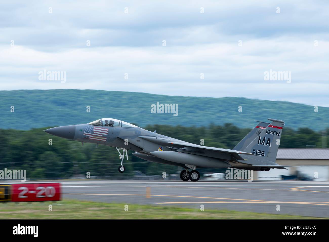 A U.S. Air Force F-15C Eagle, assigned to the 104th Fighter Wing, lands June 16, 2022, at Barnes Air National Guard Base, Massachusetts. The 104FW is trained to provide around-the-clock Aerospace Control Alert, providing armed F-15 fighters ready to scramble in a moment’s notice to protect the northeast United States from any airborne threat. (U.S. Air National Guard photo by Staff Sgt. Hanna Smith) Stock Photo