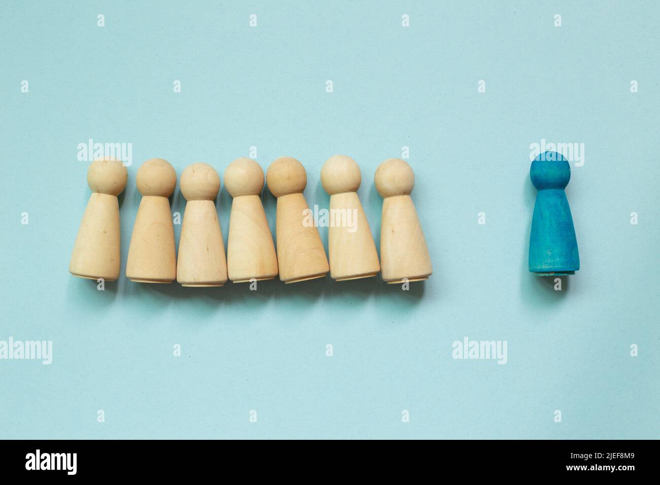 Majority vs minority concept. Wooden human figure on blue background Stock Photo
