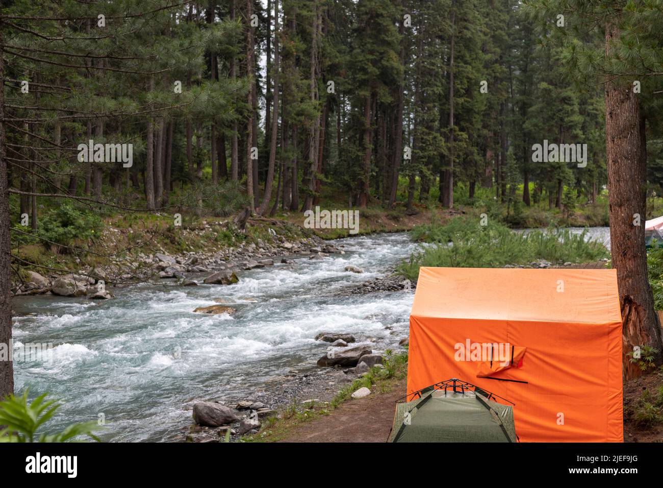 Camping on a river side in kumrat valley Stock Photo