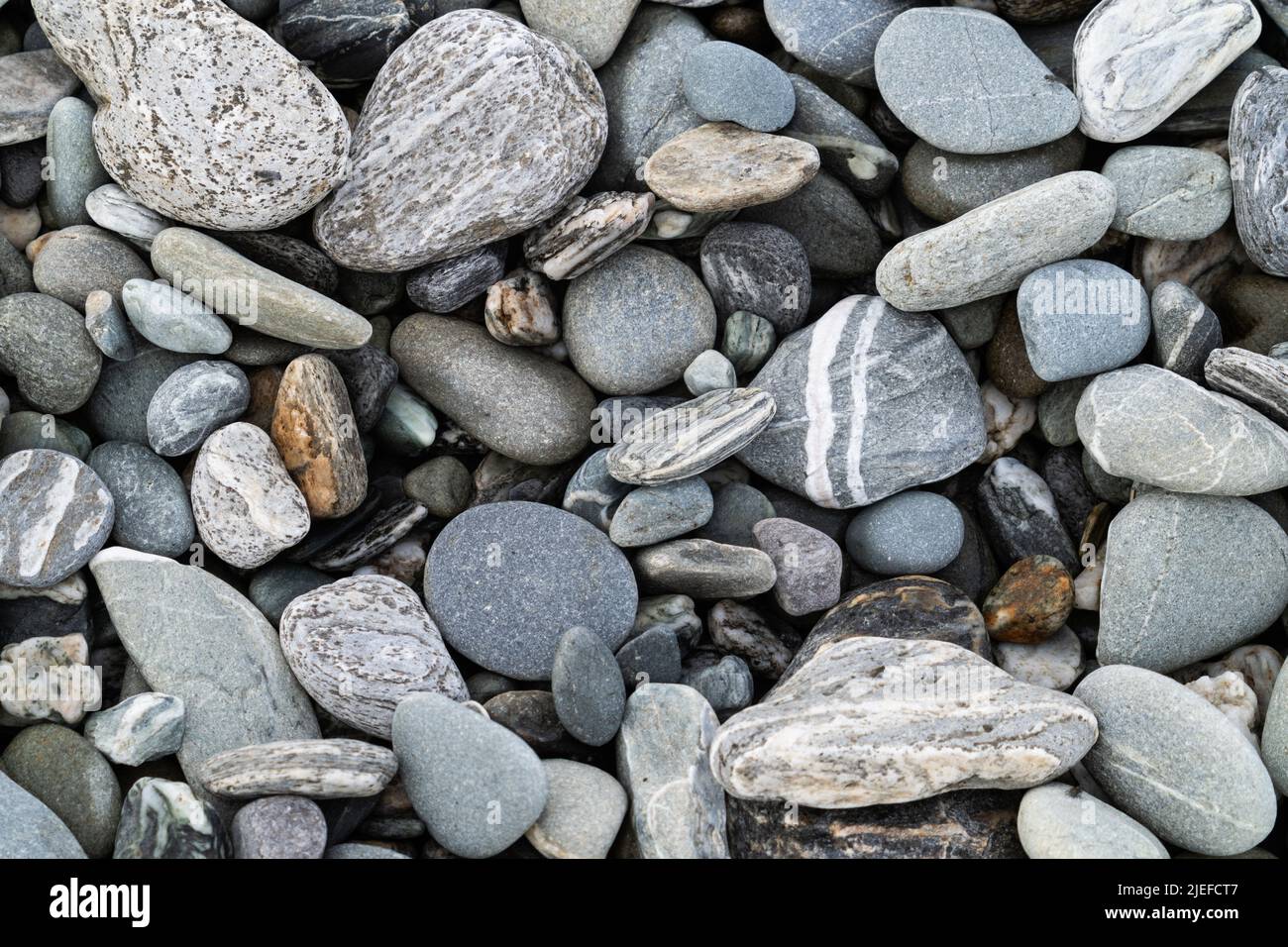 River stones in typical random pattern and type in New Zealand. Stock Photo