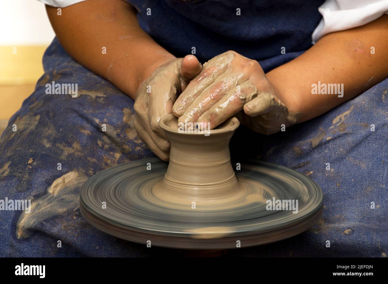Potter modeling ceramic pot from clay on a potter's wheel Stock Photo Alamy