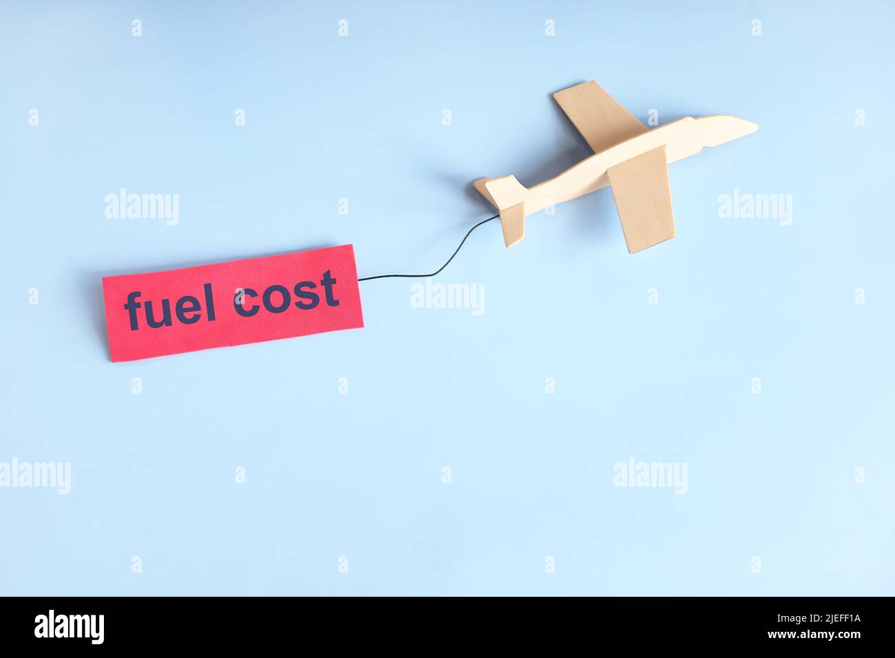 High aircraft fuel cost concept in aviation industry. wooden airplane