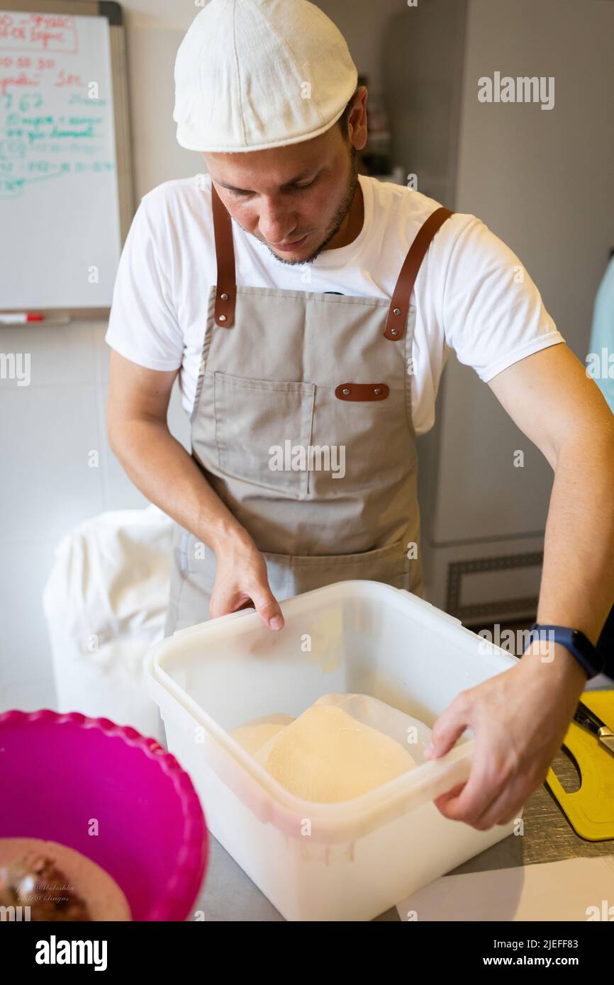 The process of making wheat bread in an artisan bakery. The folding of