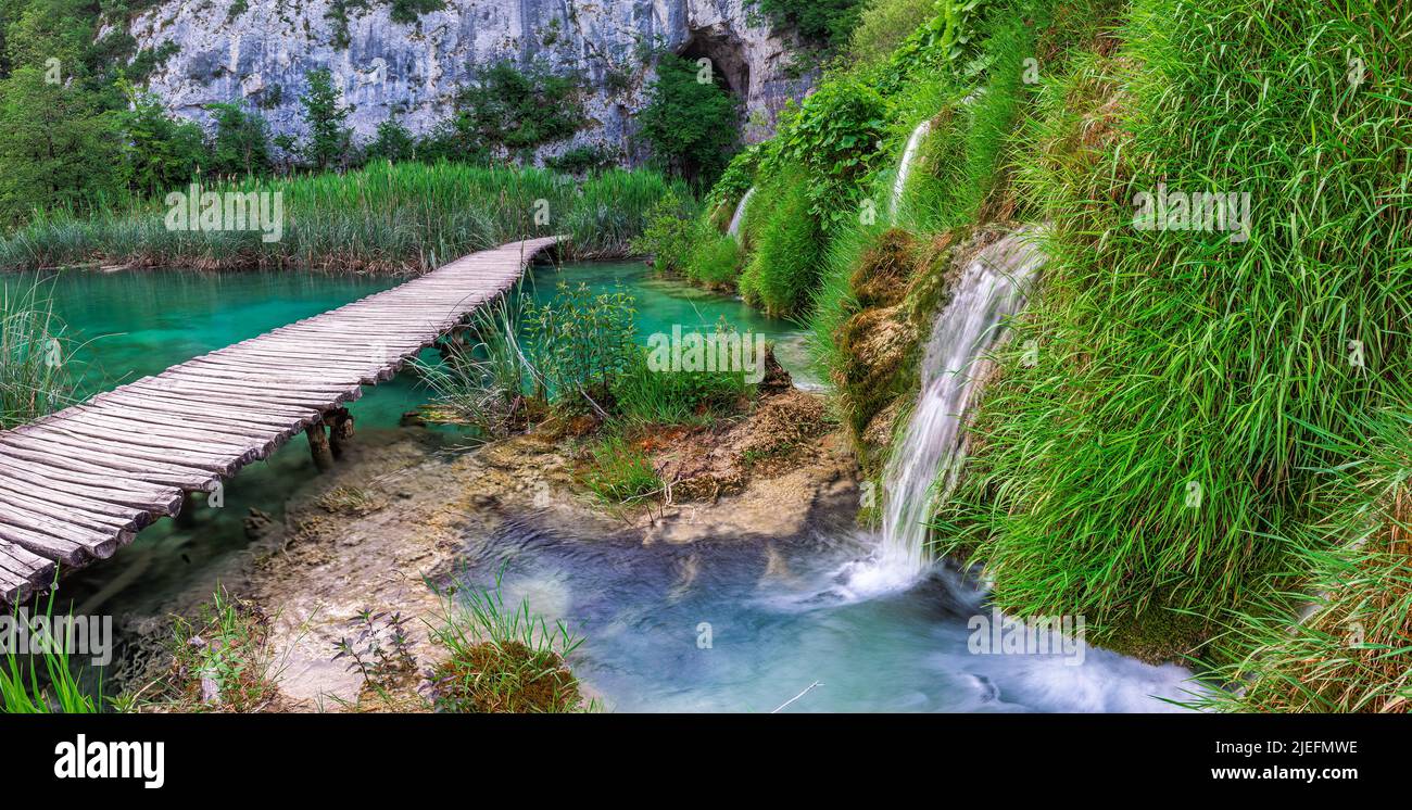 Plitvice, Croatia - Panoramic view of a wooden walkway in Plitvice Lakes National Park on a bright summer day with crystal clear turquoise water, smal Stock Photo