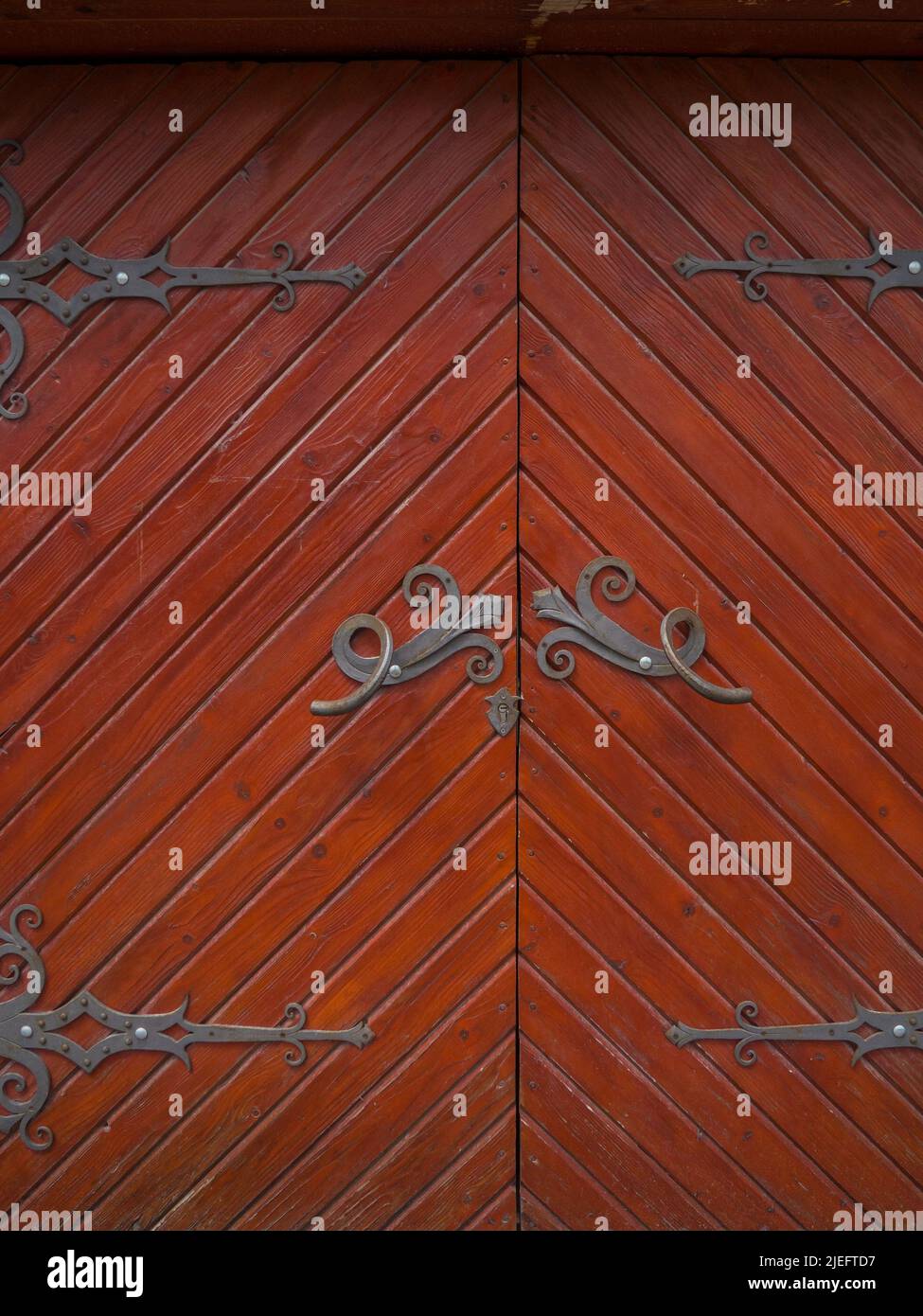 Ancient wooden door with iron curtains Stock Photo